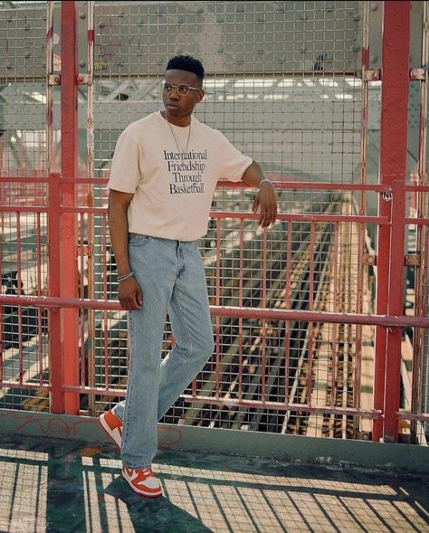 Mix between orange dunk lows, baggy blue jeans, and tucked oversized shirt brings a chill aspect to this nice outfit. Tucked Tshirt Men Outfit, Tucked In Oversized Shirt Outfit, Tucked In Shirt Outfit Men, Chill Fits For Men, Orange Shirt Outfit Men, Dunk Low Outfit Man, Oversized Shirt Men Outfits, Nike Dunk Low Outfit Men, Orange Shoes Outfit