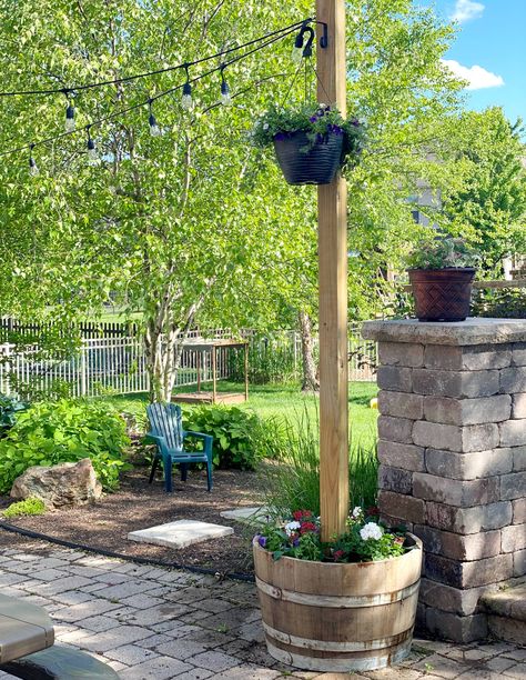 A clever, inexpensive barrel planter DIY transformed this patio space | Real Homes Wine Barrel Garden, Whiskey Barrel Planter, Wine Barrel Planter, Barrel Projects, Planter Diy, Planter Project, Patio String Lights, Barrel Planter, Deck Decorating Ideas