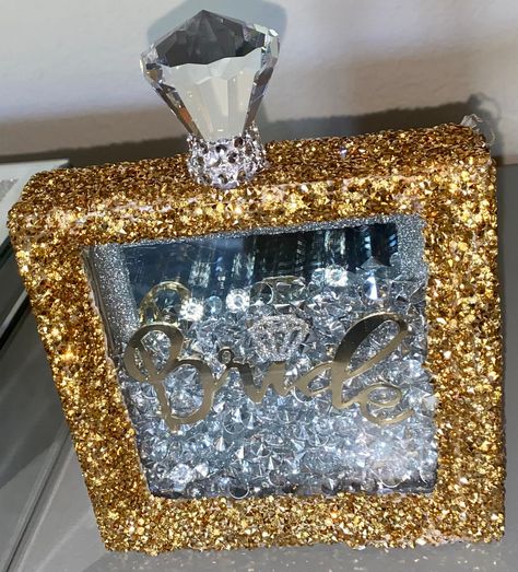 I hand made this shimmery bling shadow box with multiple detailed features including, a gold frame wrapped in sparkly gold rhinestones. Inside has a mirror backsplash for multipurpose use, crystal gems with a glittery diamond over any personalized word/name or phrase. To top of the look the box has an EXTRA large diamond crystal wrapped in clear rhinestones to mimic a perfume bottle top. Comes with or without fairy lights.  The perfect gift for a Bride or Bride to be. 💗Can be personalized  💗Fo Moon Wedding Theme, Glass Mosaic Mirror, Mosaic Tile Mirror, Mirror Backsplash, Bling Crafts, Black Gold Ring, Jewelry Wall, Diamond Bling, Bottle Top