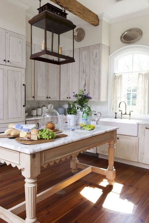 French Country Kitchen Decor with Marble Top Wood Table Island, Lantern Chandelier, wood Cabinets, and farmhouse sink Rustic Farmhouse Style Kitchen, French Country Kitchen Designs, Rustic Farmhouse Kitchen Cabinets, Freestanding Kitchen Island, French Country Decorating Kitchen, Country Kitchen Designs, French Country Kitchens, Casa Country, Farmhouse Kitchen Cabinets