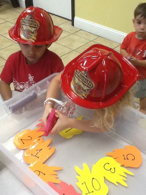 Great activity for a firefighter theme week at preschool. The kids loved spraying out the fire! Put Out The Flames Preschool, Firefighter Games Preschool, Career Preschool Activities, Fire Safety Games For Preschoolers, Fire Fighter Crafts Toddlers, Fire Fighter Activity For Toddlers, Community Helper Kindergarten Activities, My Community Preschool Theme Activities, Community Helper Toddler Activities