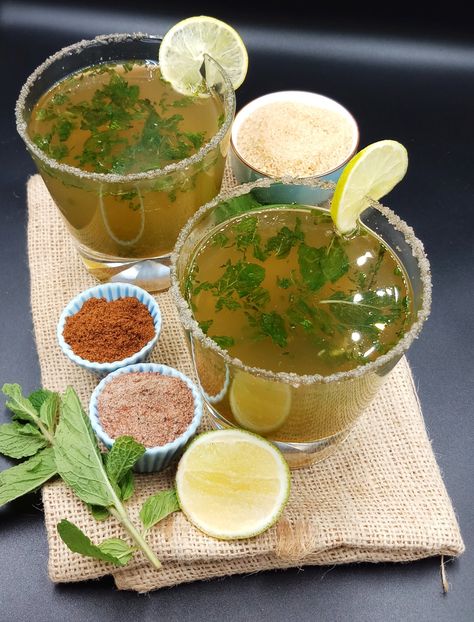 Masala Shikanji (Indian lemonade) is in glass on jute mat with lemon, sugar, mint, roasted cumin powder and black salt. Masala Shikanji, Masala Lemonade, Shikanji Recipe, Indian Lemonade, Homemade Masala, Lemonade Water, Mango Powder, Spicy Drinks, Dried Mango