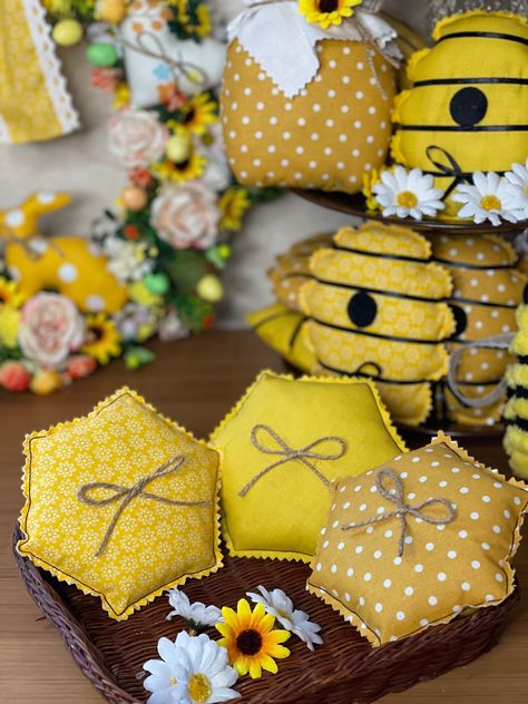 Honeycomb Fabric honeycombs Honey hive decor for kitchen Honey decor Honey jar Honey honeycombs Summer decor for home Summer tiered Our handmade honeycombs are sewn from yellow cotton fabric and filled with polyfill. The honeycomb is decorated with a jute bow. These cute honeycombs will add a touch of sparkle to a tiered tray or simply be a focal point in your summer decor. It is a perfect gift for friends, dad or mom. They look charming in a table setting or on a tray. Approximate dimensions: length - 4.8 inches (12 cm) width - 4.8 inches (12 cm) Note! Actual colors may differ slightly from their appearance on the display, as it depends on the monitor settings. For other great honey decor fillers check out my other listings!! We believe you must have plenty of honey jewelry in these summe Hive Decor, Bee Hive Craft, Honey Hive, Honey Decor, Mini Pillows, Honeycomb Fabric, Sunflower Crafts, Honey Bee Decor, Ladybug Crafts