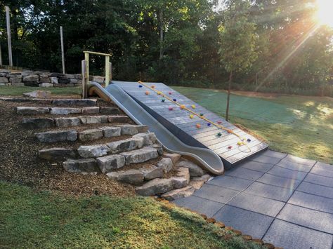 Retaining Wall Play Area, Play Area On Hill, Playground Built Into Hill, Slide Built Into Hill, Downhill Backyard Ideas, Hill Playground Ideas, Playground On Sloped Yard, Playset On Sloped Yard, Sloped Backyard Playground