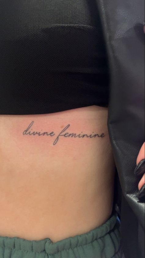 tattoo idea Women Tattoos Underboob, Devine Femine Tattoo, Devine Feminine Tattoo Ideas, Devine Feminine Tattoos For Women, Divine Feminine Tattoo Cursive, Feminine Word Tattoos, Define Feminine Tattoo, Divine Tattoo Ideas, Underboob Word Tattoo