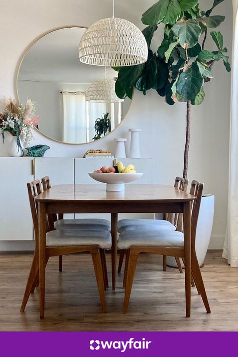 Give your dining room a boho makeover with rattan lighting, wooden dining table, and round gold mirror. Proof that small updates can make a big difference. Rattan Lighting, Round Gold Mirror, House Trim, Dinning Room Design, Wooden Dining Table, Stunning Interior Design, Apartment Decor Inspiration, Dining Room Inspiration, Wooden Dining Tables