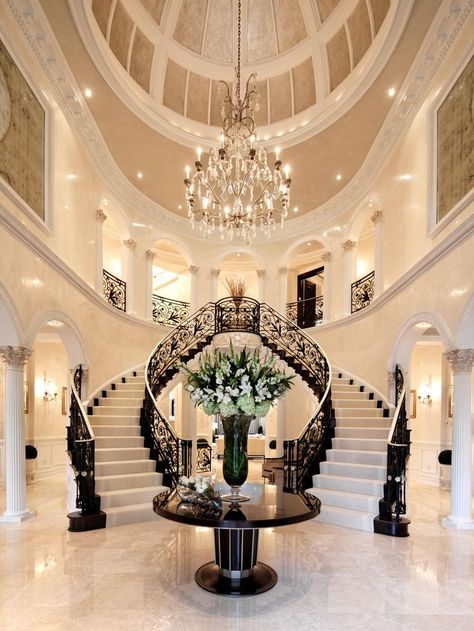 A spacious foyer with a domed ceiling and double staircase makes a grand entrance to this home. An elegant chandelier and black and white staircase complete the classic look. White Staircase, Double Staircase, Decor Ikea, Elegant Chandeliers, Versace Home, Design Room, Hallway Kitchen, Luxury Homes Dream Houses, Grand Staircase