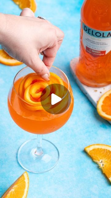 Delola on Instagram: "Make your Delola cocktails the star of the Friendsgiving table with these elegant orange rose ice cubes 🍊🍊🍊  Here’s how:  ✨Thinly cut six orange wheels, about ⅛ of an inch thick. Cut one wheel in half ✨Form five of the orange wheels into a rose shape in the ice mold ✨Roll the half wheel and place in center of rose formation in mold ✨Pour water ¾ of the way so that the orange slices are peeking out  ✨Freeze overnight  ✨Remove from freezer and add to glass  ✨Pour Delola L’Orange over ice rose" Orange Slice Ice Cube, Orange Ice Cubes, Rose Ice Cubes, Friendsgiving Table, Ice Rose, Orange Wheels, One Wheel, Ice Molds, Rose Orange