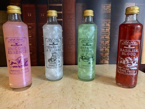 Our most popular and magical product! Get all 4 of our potions including Serpents Venom (Lemonade), Basilisk Blood (Mixed Fruits), Tears of A Wizard (Cream Soda), and Unicorn Essence (Fruit Twist).They come in 250ml bottles and the potions come to life with a magical shimmer when you use the potion spell.The potions are all sugar free and mix well with poisons such as gin, vodka and rum. Drinkable Potions, Potions Shop, Magical Drinks, Making Potions, Drink Ingredients, Potion Making, Sugar Free Drinks, Drink Cart, Carbonated Water