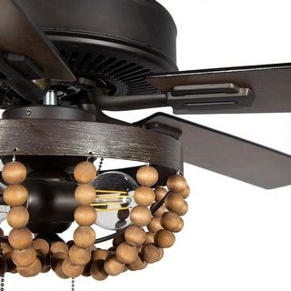 With an eclectic, Bohemian design and a sleek finish, this gorgeous ceiling fan is sure to stir things up. Two LED lights surrounded by artful wood beads make for a distinct aesthetic as this chic ceiling fan cools your home. The five blades are reversible, displaying your choice of rich barnwood or light driftwood finishes. Features: 5-blade ceiling fan Wooden beaded chandelier shade Brown and oil-rubbed bronze fixture finish Temperature-efficient with reversible blades Blades reverse from rich Wooden Ceiling Fans, Tropical Ceiling Fans, Wooden Bead Chandelier, Living Room Ceiling Fan, Creek House, Chandelier Led, Farmhouse Ceiling Fan, Wooden Shades, Bronze Ceiling Fan