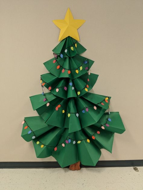 3-D Christmas tree bulletin board. Diy Christmas Tree Classroom, Classroom Paper Christmas Tree, Paper Christmas Tree Door Decoration, Christmas Decoration Bulletin Board, Christmas Tree For Classroom Door, Christmas Tree Out Of Construction Paper, Office Christmas Bulletin Board, Bulitin Board Ideas Christmas, Paper Christmas Tree Bulletin Board