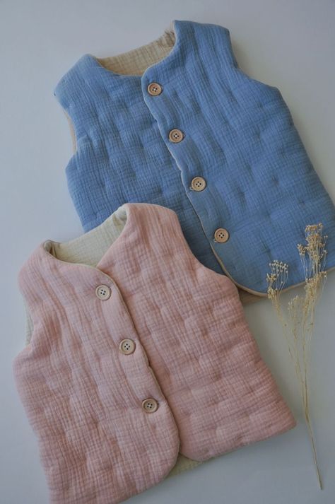 So soft and lovely organic cotton quilted vest! Padded muslin waistcoat can be sewn for boys and girls from 1 to 9 years from various double gauze fabric colors. Kids vest is decorated with a wooden buttons. Click to find other fabric colors! #kidsstyle #kidswear #kidsvest #childrenvest #kidsjacket #toddlerstyle #toddlerwear #paddedvest #muslinvest #muslinkidswear #organickidswear #timelesskidsclothes #kidsclothes #slowkidsfashion Vest With Buttons, Baby Clothes Patterns Sewing, Organic Kids Clothes, Toddler Wearing, Children Wear, Kids Vest, Kids Blouse, Baby Clothes Patterns, Toddler Dolls