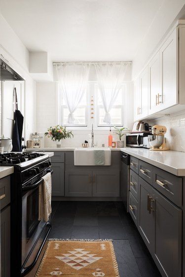 What kind of kitchen flooring should you pair with your neutral cabinets? Luckily, gray pairs well with all sorts of floors. Check out some of our favorite kitchen flooring ideas with gray cabinets for inspiration. #kitchen #kitchenflooring #flooringideas #kitchenflooringideas Slate Floor Kitchen, Kitchen Flooring Ideas, Kitchen Triangle, Slate Floor, Gray And White Kitchen, Small Kitchen Layouts, Flat Panel Cabinets, Gray Cabinets, U Shaped Kitchen