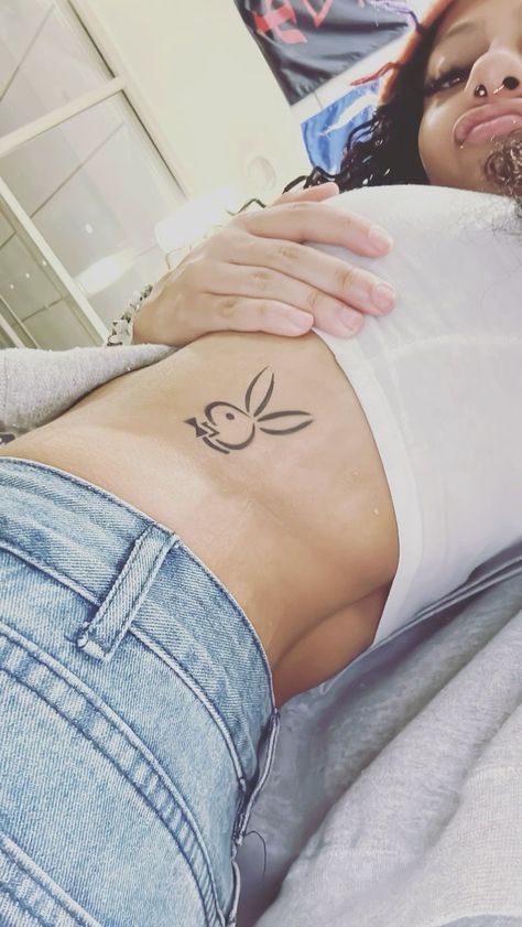 Rib And Stomach Tattoos For Women, Playboy Tattoo Design, Bad Girls Club Tattoo, Play Boy Tattoo, Playboy Bunny Tattoo Design, Panty Line Tattoo, Playboy Bunny Tattoo, Playboy Tattoo, Watercolor Tattoo Ideas