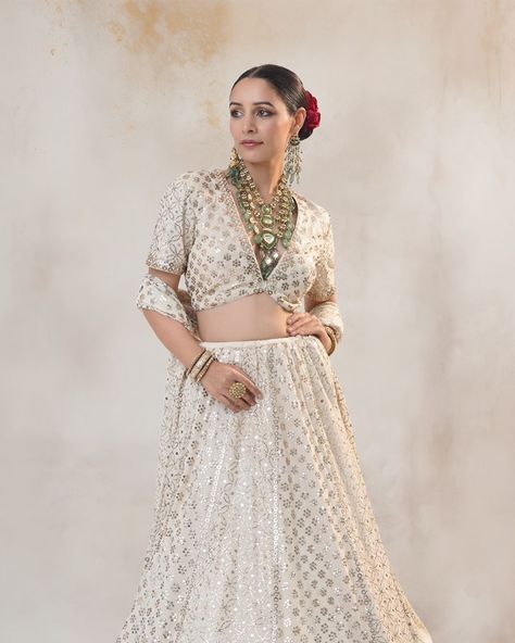 Elevate your ethnic wardrobe with our designer Mukaish Chikan Kari Off-White Lehenga. Crafted with meticulous attention to detail, this ensemble exudes timeless elegance and traditional charm. Adorned with delicate Rose Gold Mukaish work on Silk Georgette, the lehenga features intricate Chikan Kari embroidery, creating a mesmerizing fusion of craftsmanship. The classic off-white base color serves as the perfect canvas for the heavy Mukaish handwork, adding a touch of sophistication to the... Chikan Kari Embroidery, Mukaish Embroidery, Mukaish Work, White Lehenga, Attention To Detail, Base Colour, Lehenga, Timeless Elegance, Off White