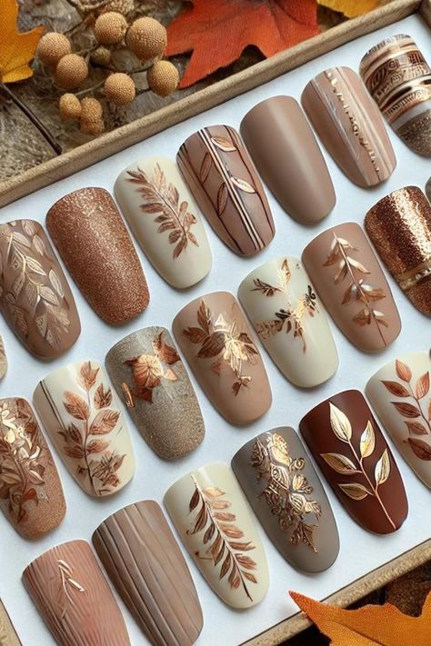 Achieve the perfect fall manicure with soft neutral nail polish, elevated by elegant leaf patterns, gold accents, and geometric designs! These autumn-inspired nails pair beautifully with cozy sweaters and seasonal vibes. 🍂✨ #FallNails #NailArt #NeutralNails #AutumnAesthetic Fall Nail Designs Rhinestones, Autumn Sweater Nails, Taupe Fall Nails, Brown Nails Autumn, Fall Glam Nails, Fall Nail Designs Pumpkin, Nails With Words On Them, Fall Style Nails, Neutral Fall Nails Gel