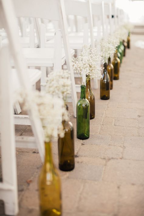 Wine Bottle Centerpiece For Wedding, Centerpiece With Wine Bottles, Simple Wedding Centerpieces Wine Bottles, Recycled Wine Bottles Wedding, Wine Bottle Aisle Decorations Wedding, Wine Bottle Vase Wedding, Wedding Decor Wine Bottles, Brown Glass Bottles Wedding, Wine Bottle Aisle Decor