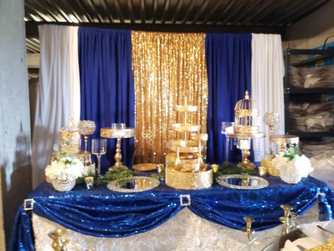 Gold and Royal blue dessert table design. www.revesetheres.com EVENT DESIGN AND MANAGEMENT Quinceanera Royal Blue Gold Table Setting, Blue Gold Birthday Decor, Gold And Blue Party Decor, Royal Blue Sweets Table, Dessert Table Ideas Blue And Gold, Blue Gold Dessert Table, Royal Blue Party Decor, Wedding Royal Blue And Gold, Gold And Blue Decorations Party Ideas