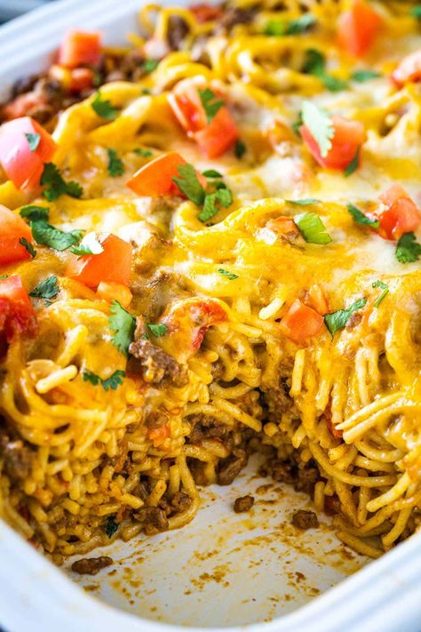 Try my Taco Spaghetti Bake tonight! It is a simple recipe made in a casserole dish, full of the best of Italian and Mexican food concepts- stirred into one cheesy meal! So Yummy! Baked Mexican Spaghetti Recipes, Baked Taco Spaghetti Recipe, Taco Spaghetti Bake With Velveeta, Easy Taco Spaghetti Bake, Taco Spaghetti Bake Ground Beef, Mexican Spaghetti Casserole, Cheesy Taco Spaghetti Bake, Taco Spaghetti Casserole Bake, Taco Spaghetti With Velveeta And Rotel