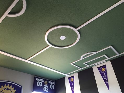 Soccer bedroom. Soccer field ceiling, Orlando City Soccer Football Ceiling Design, Soccer Display Ideas, Soccer Aesthetic Bedroom, Soccer Office Design, Soccer Room Ideas For Boys, Soccer Bedroom Ideas, Girls Soccer Bedroom, Soccer Kids Room, Kids Room Wardrobe Design