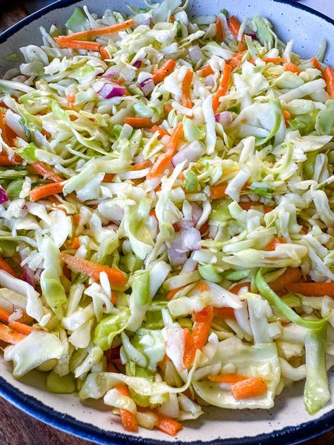 This vibrant Vinegar Coleslaw Without Mayo recipe offers a zesty alternative to traditional creamy coleslaw, perfect for those seeking a lighter and tangier option. With a crisp and crunchy mix of shredded cabbage and carrots tossed in a flavorful vinegar-based dressing, this dish is bursting with freshness. Whether served as a refreshing side at summer barbecues or as an accompaniment to your favorite sandwiches and tacos, this is sure to become a staple. Coslaw Recipes Vinegar, Coleslaw Recipe Without Mayo, Coleslaw Vinegar Based, Easy Vinegar Coleslaw Recipe, Creamy Vinegar Coleslaw Recipe, Cole Slaw Without Mayo, Shredded Cabbage Recipes Healthy, Vinager Coleslaw Recipe Vinegar, Coleslaw Dressing Vinegar