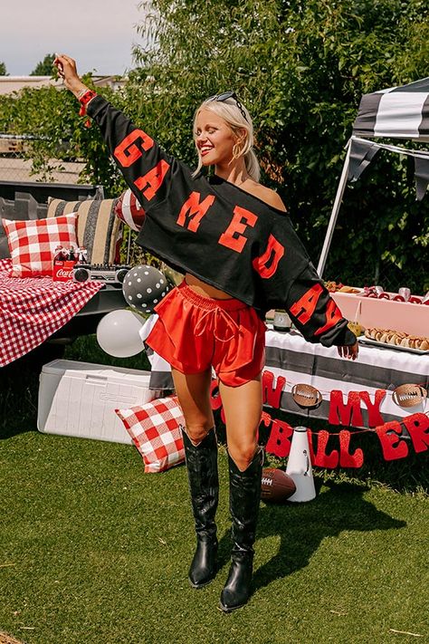 - Gear up for game day with this trendy crop sweatshirt! It's the perfect piece for cheering on your team or adding a sporty chic vibe to your casual wardrobe. - Unlined lightweight sweatshirt material with unfinished frayed seam accents - 'GAME DAY' lettering across the sleeves and front - A boat cut neckline - Long sleeves with ribbed cuffs - An ultra relaxed silhouette that ends in a cropped hemline - This piece is perfect for fans of Arkansas, Georgia, Texas Tech, Alabama, Oklahoma, and more Black And White Gameday Outfits, Football Outfits For Women Games, A&m Gameday Outfit, Kc Chiefs Outfit Ideas Women, Nfl Wife Outfits Black Women, University Of Alabama Game Day Outfits, Gameday Photoshoot, Winter Football Game Outfit Cold Weather, Winter Game Day Outfit