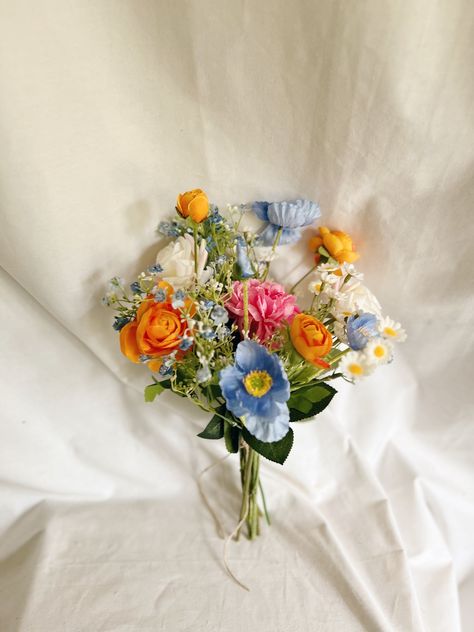 This beautiful bunch of faux flowers consists of poppies, ranunculus, roses, daisies and fillers of blue, orange, cream and hot pink colors . It will be a perfect touch to any table.  Arrangement measures: W- 7" , H - 12 "approx. Matching bridal and bridesmaids bouquets, toss bouquet, corsages and boutonnières and other accessories are available. Fall Bouquets For Bridesmaids, Wedding Arbor Colorful Flowers, Simple Colorful Wedding Bouquet, Burnt Orange And Light Blue Wedding, Formal Wedding Flowers, Colorful Florals Wedding, Colorful Centerpieces Wedding, Late Summer Wedding Flowers, Colorful Bridesmaid Bouquet