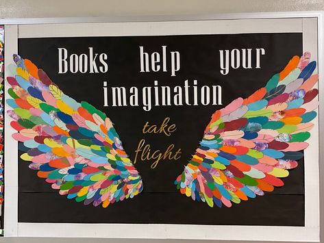 Library bulletin board with multicolor wings and text that says “Books help your imagination take flight” Angel Wings Bulletin Board, Imagination Bulletin Board Ideas, Bird Theme Decorating Ideas, Imagination Bulletin Board, Feather Bulletin Board, Watch Us Soar Wings Bulletin Board, Angel Theme Decorations, Wings Bulletin Board Ideas, Fantasy Bulletin Board