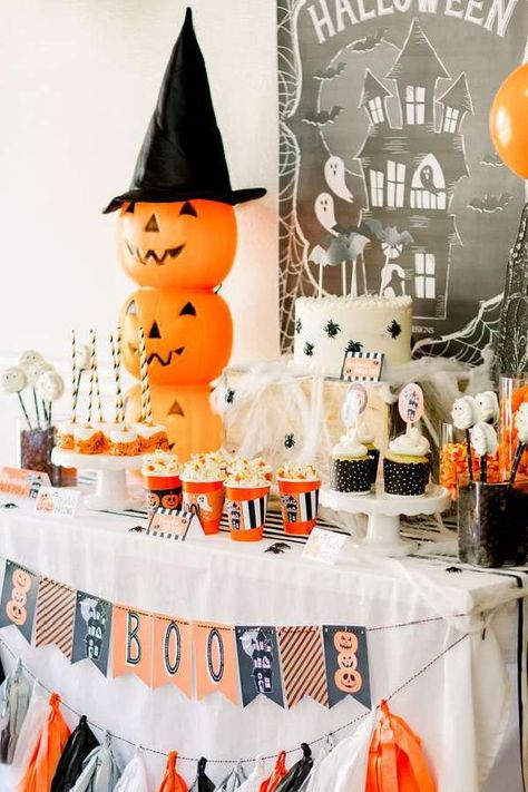 Check out this spooktacular Halloween bash! Love the decorations!! See more party ideas and share yours at CatchMyParty.com Halloween Party Table Setup For Kids, Trick Or Treat Booth Ideas, Halloween Party Table Decor, Cheap Easy Halloween Decorations, Halloween Work Party, Halloween Party Centerpieces, Elegant Halloween Party, Halloween Party Table Decorations, Kids Halloween Party Decorations