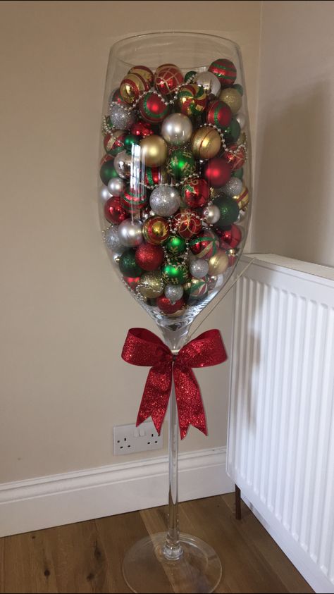 Giant wine glass filled with baubles 🎄 Giant Wine Glass Decor Ideas, Giant Wine Glass Decor, Wine Glass Gift Ideas Filled, Christmas Terrariums, Wine Glass Christmas Crafts, Christmas Pub, Wine Glass Christmas Decorations, Huge Wine Glass, Wine Glass Gifts Ideas