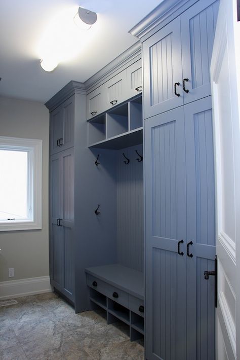 Blue mudroom with floor to ceiling cabinets & beadboard trim doors. Mudroom also includes a built-in bench, hooks, and stone floors. Beadboard Trim, Transitional Laundry Room, Vstupná Hala, Floor To Ceiling Cabinets, Mudroom Cabinets, Laundry Room/mud Room, Room Storage Diy, Mudroom Organization, Mudroom Entryway