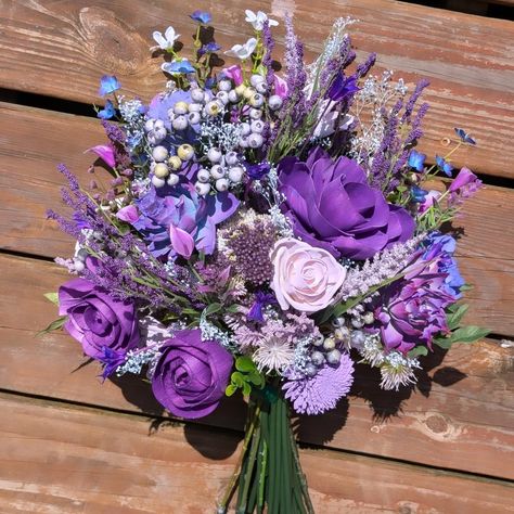 Shades of purple pop with vibrancy in this wild bouquet! We used @unicornspitstain for each shade and tint - we even used SPARKLING violet! Those roses shimmer! Greenery and filler from @pioneerimports ! Our luxury wood flowers have never looked better! Perfect bridal bouquet! #lttlteapotdesigns #luxurywoodflowers #littleteapotdesigns #woodflowers #woodflowerflorist #weddingtrends #weddinginspo #weddinginspiration #weddingstyle #bride #bridal #bouquet #flowers #floraldesign #florist #maryla... Purple Lilac Bouquet, Violet Bouquet, Wild Bouquet, Bridesmaids Flowers, Hoco Inspo, Purple Bouquets, Lilac Bouquet, Flowers Wine, Wedding Wine Bottles