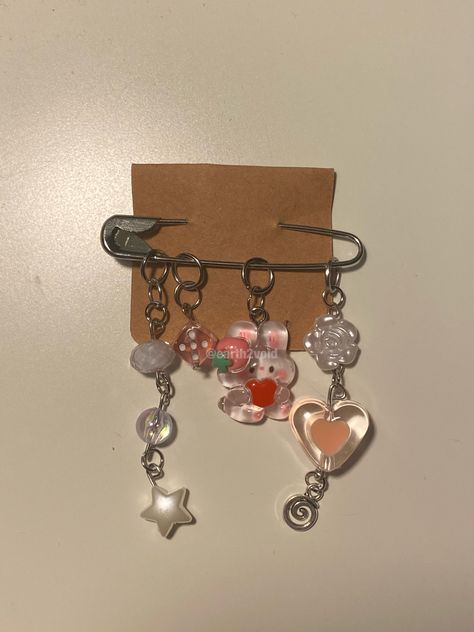 safety pin accessory made with a bunny pendant along with pink clear and white beads and a small silver swirl pendant add on. String Friendship Bracelets, Handmade Keychains, Fairy Jewelry, Diy Pins, Kawaii Accessories, Miniature Crafts, Handmade Wire Jewelry, Diy Keychain, Beaded Keychains