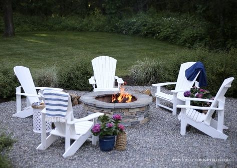 A classic New England pea stone patio and fire pit surrounded by white Adirondack chairs is the perfect spot for summer nights Adarondic Chairs Around Fire Pit, Pea Stone Patio, Patio And Fire Pit, White Adirondack Chairs, Pea Stone, Paver Fire Pit, Solo Stove, House Patio, Deck Makeover