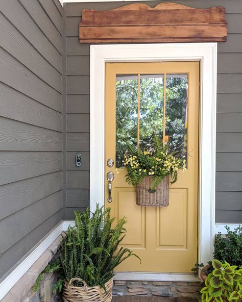 Colored Accent Door, Dark Green House Yellow Door, Leap Of Faith Benjamin Moore Front Door, Yellow Front Door Cottage, Muted Yellow Front Door, Tan House Door Color, Benjamin Moore Leap Of Faith, Brown House With Colored Front Door, Outdoor Door Color Ideas