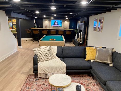 Unfinished Basement Black Ceiling, Industrial Rustic Basement, Exposed Ceiling Basement Ideas, Basement With Black Painted Ceiling, Spray Painted Basement Ceiling, Industrial Basement Design, Finished Basement With Black Ceiling, Lounge Basement Ideas, Spray Paint Basement Ceiling