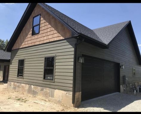 Black Metal Siding House, Black Garage Doors Green House, Garage Exterior Color Ideas, Green Black And Cedar Exterior, Olive House Black Trim, Dark Green And Brown Exterior House Colors, Green House What Color Door, Sage Green House Exterior Black Trim, Dark Green Exterior House Colors Cedar Shakes