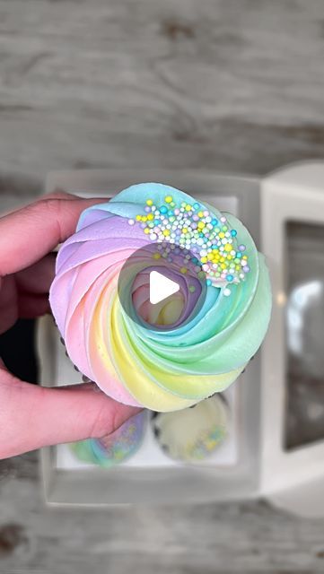 Jillian Vinion on Instagram: "Dreamy rainbow swirls 🌸🌈✨☁️ This is my favorite way to fill pipe colorful swirls! There are multiple ways to do this but I have always preferred this method: use your spatula/spoon to line the buttercream colors on plastic wrap, roll it tightly, snip the top off, and then place it in the piping bag. It gives the prettiest colorful swirls each and every time✨🫶🏻 oh and this tip is just pure magic!  . Piping tips/nozzles: 1G . . #bakedwithlove #cake #cakes #cakephoto #cakesofinstaagram #cakedesign #cakeideas #cakeinspo #cakeinspiration #cakemaker #cupcakelove #bake #fyp #cupcakeart #foodreel #reelsofinstagram #reelsviral#bakedgoods #reeltrending #cupcakelove #prettycupcakes #cupcaketrends #buttercream #americanbuttercream . . Chocolate cupcakes. Cupcake. Cake Piping Rainbow Frosting, Multi Colored Icing Piping, Rainbow Flower Cake Birthday, Piping Tutorial Icing, Multi Color Frosting Piping, Rainbow Swirl Cupcakes, Rainbow Icing Cupcakes, Cake Nozzles Piping Tips, Rainbow Frosting Cupcakes