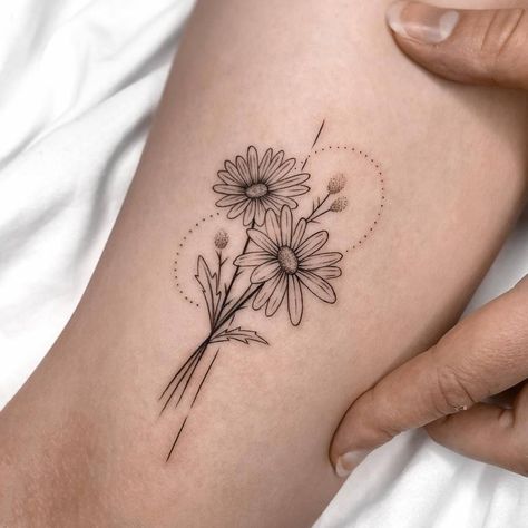 Beautiful daisy flowers tattooed on the inner arm. Womens Inner Arm Tattoo Ideas, Wrap Around Daisy Tattoo, Daisy And Stars Tattoo, Blooming Daisy Tattoo, Daisy And Bird Tattoo, Snow Drop And Daisy Tattoo, Flower Tattoo On Inner Arm, Daisy Tattoo Inner Bicep, Daisy Birth Month Tattoo