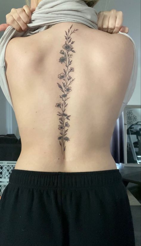 Asthetic Tattoos Spine, Back Tattoos Delicate, Cosmos Spine Tattoo, Vine On Spine Tattoo, Spine Tattoos On Women, Curvy Spine Tattoo, Floral Tattoo Design Spine, March Flower Spine Tattoo, Spinal Tattoo Floral