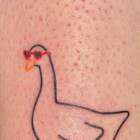 Patrycja ✿ handpoke tattoos ❋ Wrocław on Instagram: "That cute goose spent the whole summer in those heart shaped glasses and had to wait till now to be published. Give her some love 🦆❤️ ______ GUEST SPOTS: 🇫🇷 Paris 20-22.03 DM to book 💌 #handpoke #cutetattoo #stickandpoke #polandtattoos #wroclawtattoo #wroclove #paristattoo #francetattoo #frenchtattoo #lyontattoo #goosetattoo #ducktattoo #heartglasses #birdtattoo #polskietatuaze #kawaiitattoo" Goose With Glasses Tattoo, Silly Goose Tattoo Matching, Mother Duck Tattoo, Duck With Sunglasses Tattoo, Funny Goose Tattoo, Heart Shaped Glasses Tattoo, Goose Outline Tattoo, Heart Shaped Tattoos, Cute Duck Tattoo