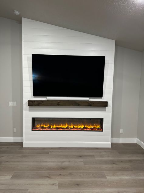 Electric Fireplace And Mantle Ideas, Diy Electric Fireplace Wall Slanted Ceiling, Electric Fireplace Ideas With Tv Angled Ceiling, White Shiplap Electric Fireplace Wall, Electric Fireplace Ideas With Tv Half Wall, Floor To Ceiling Electric Fireplace, Diy Electric Fireplace Wall Vaulted Ceiling, Slanted Wall Fireplace, Electric Fireplace Ideas With Tv And Sound Bar