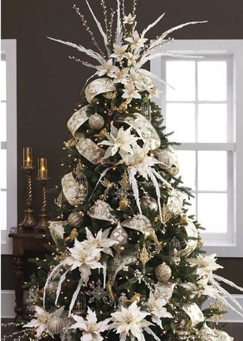 Thick ribbon and oversized flowers fill up this whimsically topped Christmas tree. Amazing Christmas Trees, Christmas Tree Inspiration, Beautiful Christmas Trees, Silver Christmas, Christmas Tree Themes, Noel Christmas, Elegant Christmas, Blue Christmas, Decoration Christmas