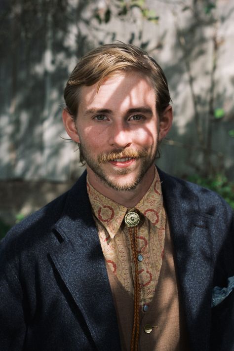 Groom with mustache and beard wearing a navy wool suit jacket, patternered shirt, brown best and bolo tie while standing in the shadow of a tree and tree branches. Bolo Tie Wedding, Navy Wool Suit, Groom Ties, Catskill Mountains, Groom Wear, Ny Wedding, Digital Weddings, Wedding Ties, Bolo Tie