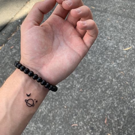 Wee little star/planet tattoo Guy Tattoos Ideas Aesthetic, Aesthetic Tattoo Designs Men, Star Planet Tattoo, Aesthetic Tattoos For Men, Stars Tattoo For Men, Ideas Tatuajes Hombre, Boys Tattoo Ideas, Mini Tattoos Men, Small Planet Tattoo