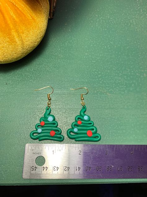 These earrings are made of non-toxic polymer clay and nickel-free metal. Each one is shaped and assembled by hand. These mini christmas trees are the statement piece you need to be festive this holiday season! Christmas Tree Earrings Clay, Clay Christmas Jewelry, Easy Christmas Polymer Clay Earrings, Fimo Christmas Earrings, Grinch Clay Earrings, Christmas Tree Polymer Clay Earrings, Earrings Christmas, Polymer Clay Christmas Ideas, Polymer Clay Christmas Tree