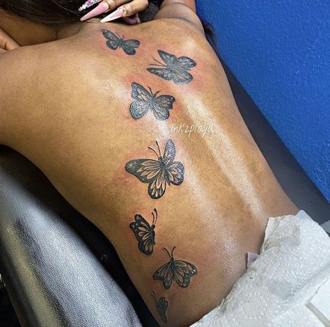 Butterflies Down Back Tattoo, Butterfly Going Up Back Tattoo, Butterflies On The Back Tattoo, Butterflies Across Back Tattoo, Tattoo Ideas Butterfly Back, Colored Butterfly Tattoo Black Women, Back Tattoo Women Butterflies, Butterfly Back Tattoo Women Black, Butterfly Tattoos For Women Back