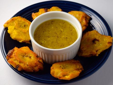 Tostones (Fried Plantains) with Mojo (Garlic Sauce) :http://www.cheftimestwo.com/tostones-fried-plantains-with-mojo-garlic-sauce/ Mojo Sauce For Tostones, Garlic Sauce For Tostones, Green Plantain Recipes, Fried Plantain Recipe, Cuban Recipe, How To Cook Plantains, Fried Plantains, Garlic Sauce Recipe, Cuban Dishes