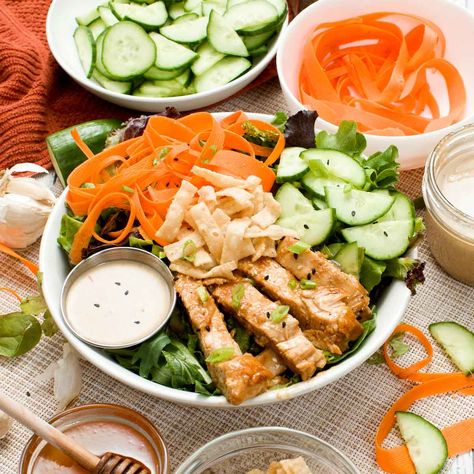 Make my high-protein Asian salad with pan-seared honey ginger chicken and a simple toasted sesame dressing with toasted sesame oil, rice vinegar, and honey.