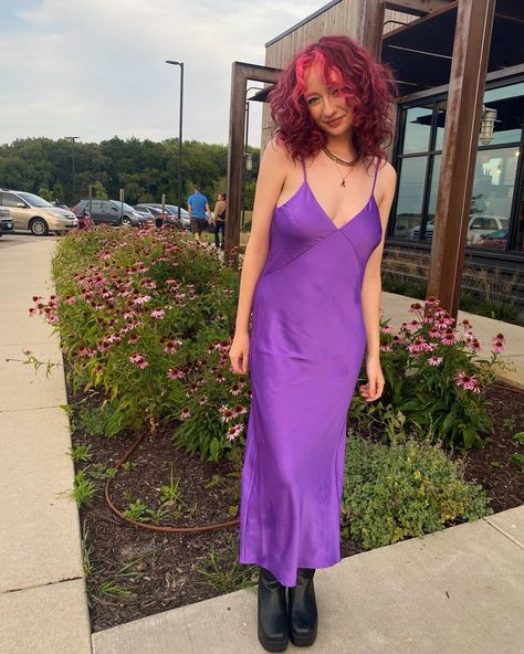 purple dress, satin dress, silk dress, black boots, pink hair, curly hair, summer, spring, gold jewelry, red hair, pink hair, hair inspo, pink bangs, pink eyebrows, gold jewelry, gold nose ring, gold septum ring, summer hair Red Hair Purple Dress, Purple Silk Dress Aesthetic, Fitted Purple Slip Dress, Spring Purple Satin Slip Dress, Purple Satin Slip Dress, Red Purple Hair, Gold Nose Rings, Black Satin Dress, Purple Hair